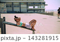 Woman practicing abdominal routines against tranquil coast side scenery 143281915
