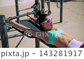 Facial expression and sunglasses emphasize effort at workout station 143281917