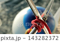Close up of a nautical rope knot securing an anchor buoy on board of moving sailing yacht 143282372