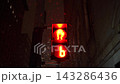 Neon Reflections On Wet Streets. City Street Illuminated By Neon Signs As Pedestrians Wait At Signals 143286436