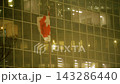 Cityscape At Night Featuring Canadian Flag Fluttering Against Shimmering Reflective Surfaces 143286440