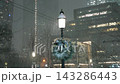 Winter City Illumination. Peaceful Urban Winter Scene With Shimmering Holiday Lights And Snow 143286443