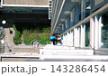 Professional Highrise Climber Descending For Exterior Window Cleaning From Above Bustling City Streets 143286454