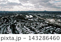 Snowy Aerial Landscape. Overhead View Of Wintery Cityscape With Icy Roads And Riverbanks 143286460