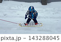 A mother teaches a little boy to snowboard. 143288045