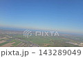 Dutch farmland wind turbines and industrial waterways seen from an airplane 143289049