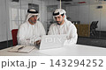 Two Arab businessmen looking at laptop, reviewing data or presentation 143294252