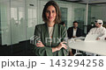 Portrait of female project manager standing in meeting room 143294258