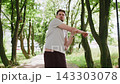 Athletic Caucasian man in sportswear stretching body and warm up before jogging workout exercises 143303078