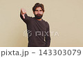 Upset unhappy Lebanese man in long sleeves showing thumbs down sign gesture against beige background 143303079
