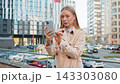 Upset businesswoman using smartphone browsing, loses becoming shocked bad news on downtown street 143303080