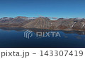 Drone shot arcing around pristine pyramid peak Abolesheva Bay Chukotka 143307419