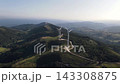 Aerial view of historic building on hilltop surrounded by lush green landscape Aerial view of historic building on hilltop surrounded by lush green landscape 143308875