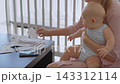 Close-up of mother holding three-month-old son in her hands. Financial stress of motherhood. 143312114