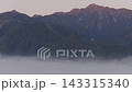 A sea of clouds and the morning glow over the Hakuba mountain range in Hakuba Village, Nagano Prefecture (aerial photography by drone). 143315340