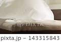 The man lift sheet over the bed and with a slow movement down it and straightens it over the entire surface of the mattress. Slow motion. Close up shot 143315843
