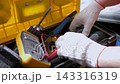 Worker Hands Choosing Tools from Toolbox Close Up 143316319