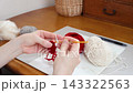 Hands of someone crocheting with yarn 143322563
