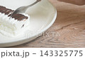 milk vanilla ice cream topping chocolate flavour arranging on plate and scooping by silver spoon 143325775