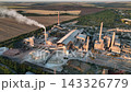 Rotary kiln and rotary drum dryers at a cement plant in a drone aerial view. Cement production infrastructure, mineral thermal treatment and construction materials 143326779