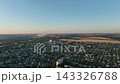 Low-rise residential neighborhoods near cement and steel plants in a drone aerial view. Urban development, real estate, residential land use and industrial employment centers 143326788