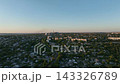 Mixed residential neighborhoods with detached houses and apartment blocks in a drone aerial view. Urban planning, real estate and neighborhood transport infrastructure 143326789