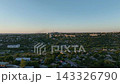 Residential neighborhoods with detached houses, apartment blocks and roads in a drone aerial view. Urban development, real estate and residential land use planning 143326790