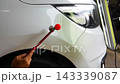 Removing dents on the car. PDR technology. Car body repair without painting. 143339087