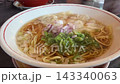 Chinese noodles topped with wontons and plenty of green onions. 143340063
