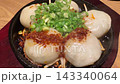 Hot plate radish cake dumplings served with plenty of green onions and spicy sauce. 143340064