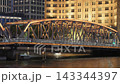 Waibaidu bridge Illuminated Golden Steel Truss Bridge Over Water in Shanghai at Night. 143344397