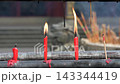 Lit Red Ritual Candles in a Buddhist Temple. 143344419