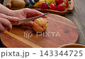 Slicing Mandarin Orange On Wooden Board For Milk Jelly Cake 143344725