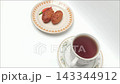 Overhead view of hot black coffee cup and fried potato croquettes 143344912