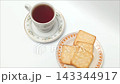 Top view black coffee cup and crispy crackers on white table 143344917