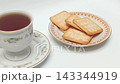Close up crisp crackers on plate next to hot black coffee cup 143344919