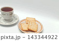 Crispy crackers on plate with black coffee cup isolated white 143344922