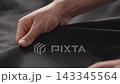 Slow motion man hands inspecting coat before season 143345564
