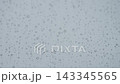 Rain drop hitting window glass and sliding down 143345565