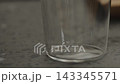 Pour milk into glass with shot of espresso 143345571