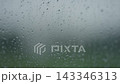 Rain drop hitting window glass and sliding down 143346313