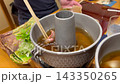The scene of shabu-shabu, where fish slices are dipped into a special broth. 143350265