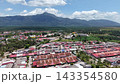 Birds eye view of Sagil township with red roofs, palm plantations and mountain backdrop in Tangkak Malaysia. 143354580