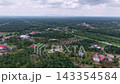 High aerial view of Ayer Baloi town and surrounding palm plantations under cloudy sky. 143354584
