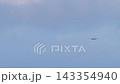 Passenger airplane approaching with landing lights in overcast sky 143354940