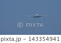 Widebody passenger airplane on final approach in clear blue sky 143354941