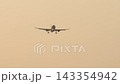 Passenger airplane on approach in golden hazy evening sky 143354942
