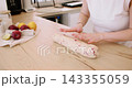 Cookies recipe. Baker work. Woman hand pressing shaping biscotti dough with cranberry on home kitchen table making healthy biscuit. 143355059