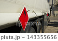 Flammability symbol on the side of a tanker truck stopped at a petrol station 143355656