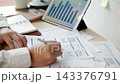Close up of businesswoman analyzing financial report document with graphs and charts on desk Close up of businesswoman analyzing financial report document with graphs and charts on desk 143376791